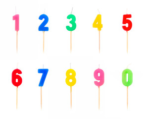 Candles in the form of figures (numbers, dates) for cake isolated on white background. The concept of celebrating a birthday, anniversary, important date, holiday, table setting, cake decoration