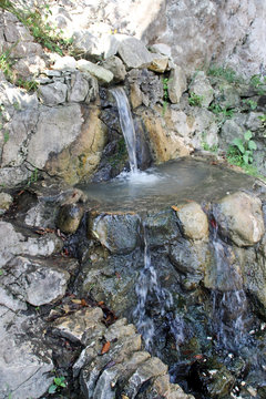 Flow of the water from the source in the rock