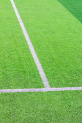 The white Line marking on the artificial green grass soccer field