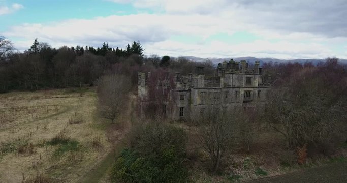 Aerial footage of  the spooky Dunmore Park House, a ruined country mansion in Tudor Gothic style near the village of Airth in Central Scotland.