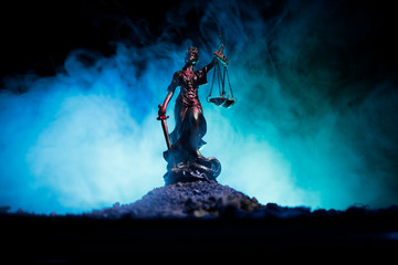 The Statue of Justice - lady justice or Iustitia / Justitia the Roman goddess of Justice on a dark fire background