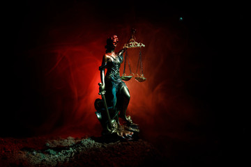 Fototapeta na wymiar The Statue of Justice - lady justice or Iustitia / Justitia the Roman goddess of Justice on a dark fire background