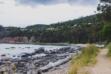 Fototapeta na wymiar deserted beach in Hobart, Tasmania with rocks and walk path