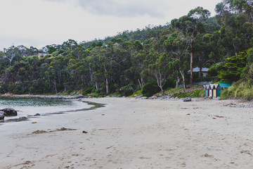 deserted beach in Hobart, Tasmania with rocks in the foreground