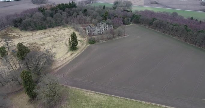 Aerial footage of  the spooky Dunmore Park House, a ruined country mansion in Tudor Gothic style near the village of Airth in Central Scotland.