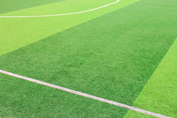 Obraz premium The white Line marking on the artificial green grass soccer field