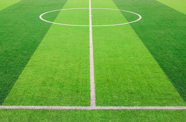Fototapeta na wymiar The white Line marking on the artificial green grass soccer field