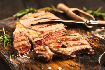 Grilled steak on wooden cutting board