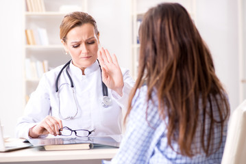 Pregnant woman visiting doctor for regular check-up