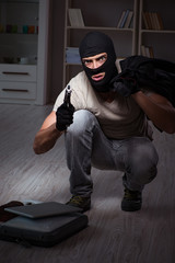 Burglar wearing balaclava mask at crime scene