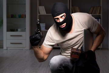 Burglar wearing balaclava mask at crime scene