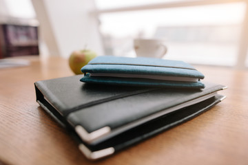 Two notepads lie on the table