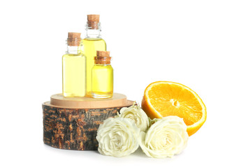 Bottles of perfume oil and flowers with lemon on white background