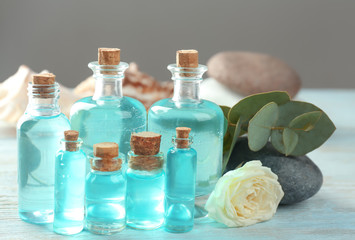 Obraz na płótnie Canvas Bottles with perfume oil on wooden table