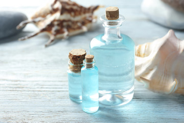 Bottles with perfume oil on wooden table
