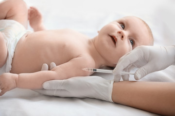 Doctor vaccinating baby in clinic