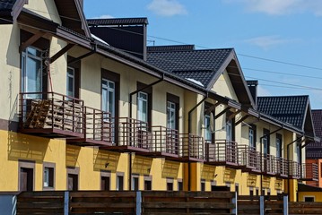 row of brown houses with windows and windows