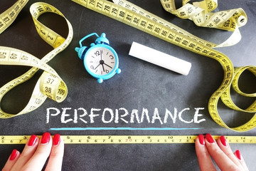 Key performance indicator or measure performance concept with ruler on chalkboard
