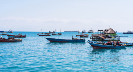 seascape with many anchored fishing boats near an african island
