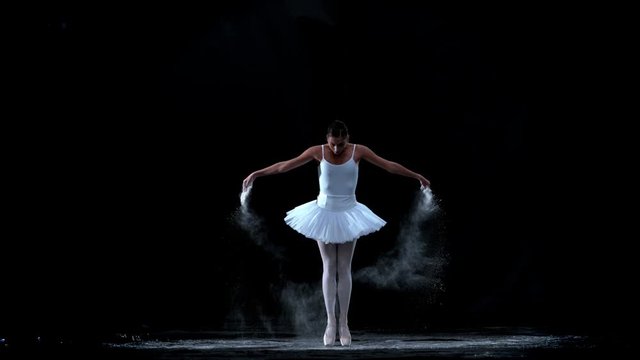 Ballerina performing on black background super slow motion