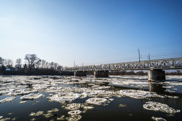 Fototapeta na wymiar bridge over a snow covered river