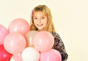 Obraz na płótnie Canvas Small girl child with party balloons, celebration. Little girl with hairstyle hold balloons. Kid with balloons at birthday. Beauty and fashion, punchy pastels. Birthday, happiness, childhood, look.