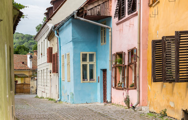Fototapeta na wymiar Colorful cobblestoned street in Sighisoara, Romania