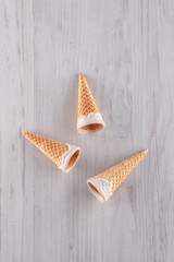 Glazed ice cream cones on a wooden background