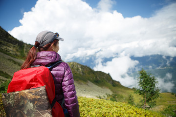 Photo of woman with backpack against of mountains