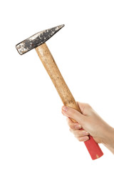 Vintage hammer in a female hand is isolated on a white background