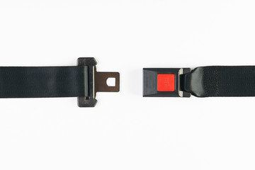 Opened seat belt isolated on white background, close-up, top view. Safety concept