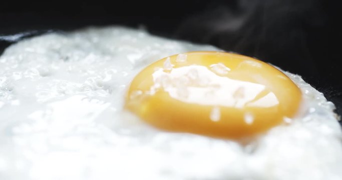 slow motion shot of egg on hot pan