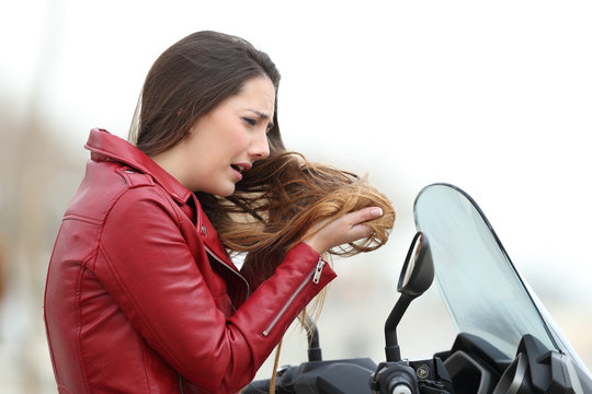 Biker woman complaining about tangled hair