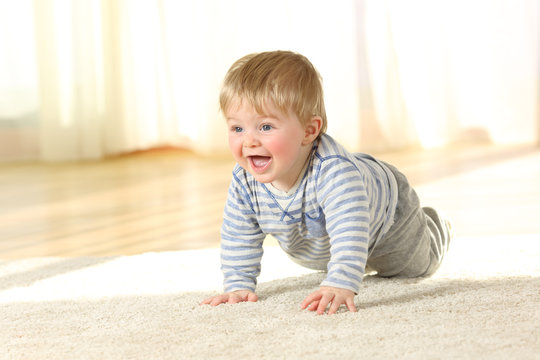 Cute baby crawling and laughing on the floor
