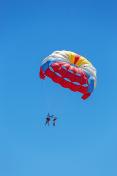 Skydivers flying high in the blue sky
