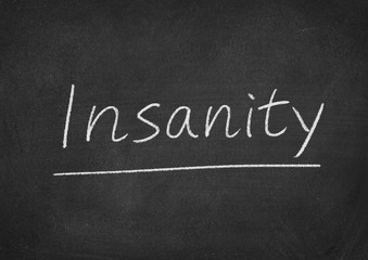insanity concept word on a blackboard background