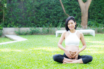 Fototapeta na wymiar Happy pregnant beautiful young asian woman with gesture hand heart shape in the park, woman with hand touch belly with relax, mother love baby, family concept.