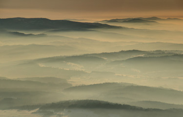 Silhouette of mountain ridges in sea of fog in glowing morning sunlight at sunrise from Babia Gora, Gorce and Beskid Sadecki ranges Beskidy Zachodnie Podhale Malopolska Poland Eastern / Central Europe