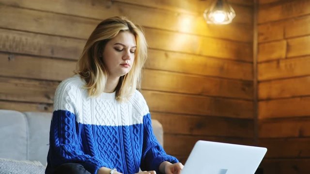 young business woman using laptop while sitting on bed smiling happy satisfied emotional face internet communication online chatting stylish girl social networking e-commerce business startup wifi