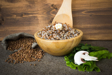 Boiled buckwheat with butter, a bag of dry cereals,  green salad leaves, champignon and parsley.