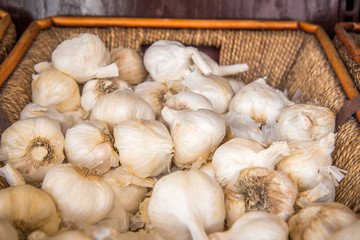 garlic at market in wooden basket 
