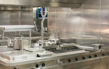 Modern stainless steel hobs in commercial kitchen