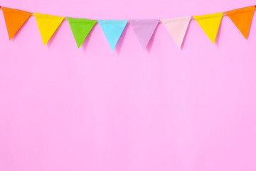 Colorful party flags hanging on pink background, birthday, anniversary, celebrate event, festival...