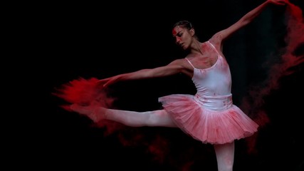 Ballerina performing on black background spinning slow motion