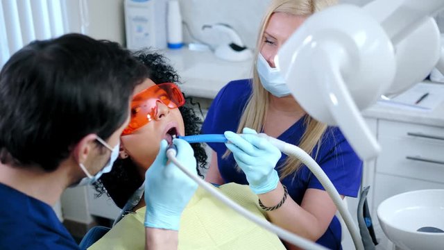 Dentist and his assitant working in private practice.
