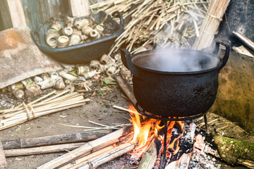 Villagers cooking in the morning using firewood as a fuel for camping in Northern Thailand - obrazy, fototapety, plakaty