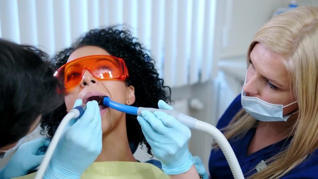 Dentist and his assitant working in private practice.