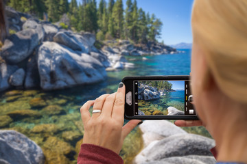 Woman Taking A Beautiful Lake Picture with Her Smart Phone
