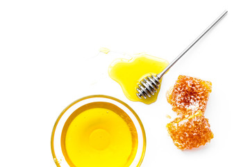 Apiary products. Honey in bowl and honeycomb on white background top view copy space close up