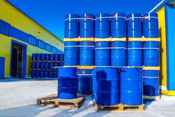Chemical reagents. The blue barrels stand on pallets. Chemical industry. A wall of barrels.